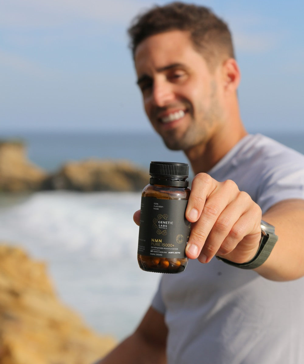 Man holding a bottle of supplements with a scenic background