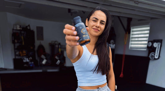 woman holding supplement bottle in front  of face