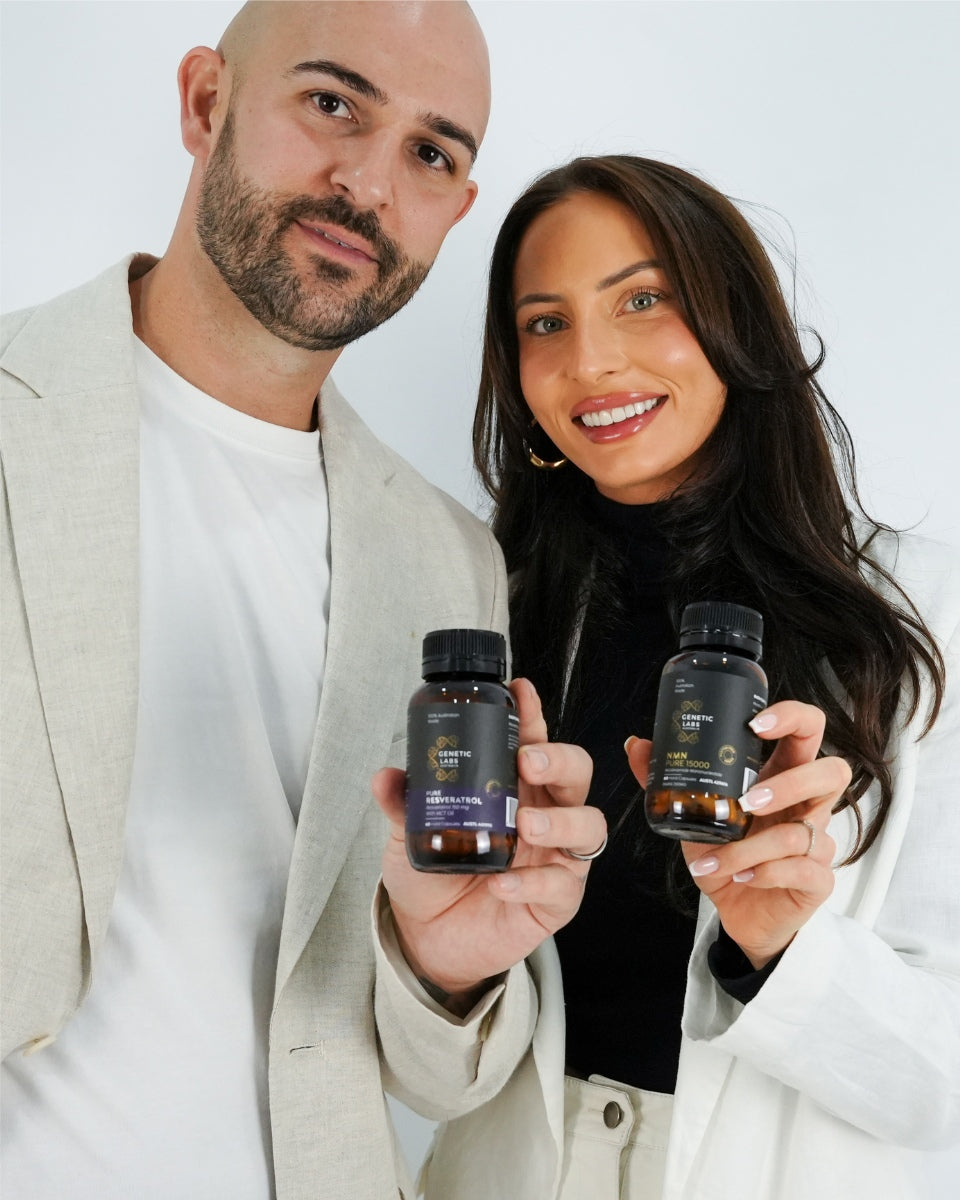 Couple holding NMN and Resveratrol bottles smiling